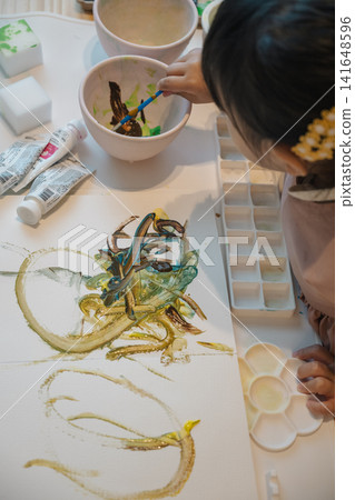 A girl playing with paint A girl playing with paint 141648596
