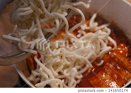 Spicy Noodles Dropped into Red Soup Bowl Spicy Noodles Dropped into Red Soup Bowl 141650174