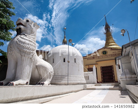 White Chinthe lion guarding the wave shaped Hsinbyume Pagoda in Mingun near Mandalay, Myanmar, iconic heritage temple in the land of golden pagodas White Chinthe lion guarding the wave shaped Hsinbyume Pagoda in Mingun near Mandalay, Myanmar, iconic heritage temple in the land of golden pagodas 141650982