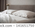 White pillows and bedding in modern cozy bedroom 141651750