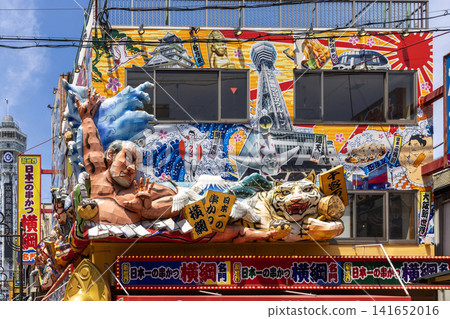 Building decorated with large sumo wrestler, tiger, and tsutenkaku tower illustrations Building decorated with large sumo wrestler, tiger, and tsutenkaku tower illustrations 141652016