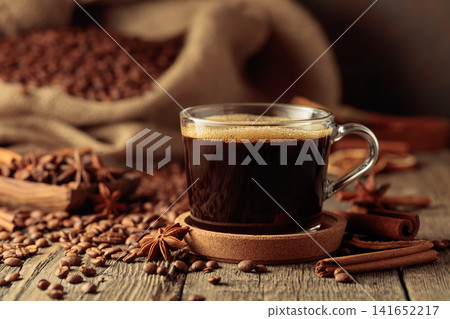 Cup of black coffee on an old wooden table. Cup of black coffee on an old wooden table. 141652217