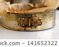 Whole homemade cherry crumb cake with golden streusel topping in a parchment-lined metal springform pan. Selective focus Whole homemade cherry crumb cake with golden streusel topping in a parchment-lined metal springform pan. Selective focus 141652322