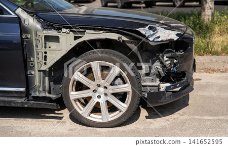Damaged black car with missing front fender and exposed inner structure after accident Damaged black car with missing front fender and exposed inner structure after accident 141652595