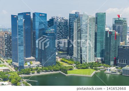 Building view of modern skyscrapers along Marina Bay in the Raffles Place financial district from the Marina Bay Sands Skypark, Singapore. Building view of modern skyscrapers along Marina Bay in the Raffles Place financial district from the Marina Bay Sands Skypark, Singapore. 141652668