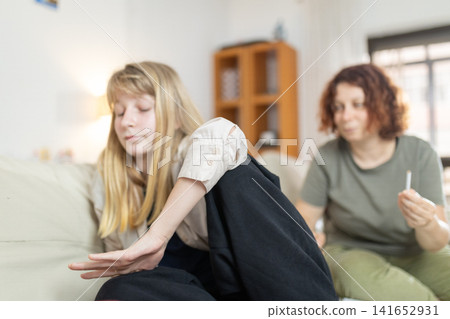 Daughter rejecting mother's drug offer at home Daughter rejecting mother's drug offer at home 141652931