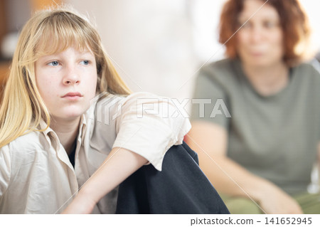 Frustrated teenage girl having serious conversation with mother Frustrated teenage girl having serious conversation with mother 141652945