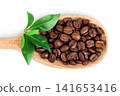 Coffee beans in wooden spoon isolated on a white background. Top view 141653416