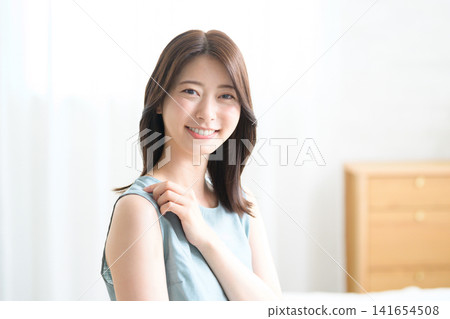 A Japanese woman smiling in her room A Japanese woman smiling in her room 141654508