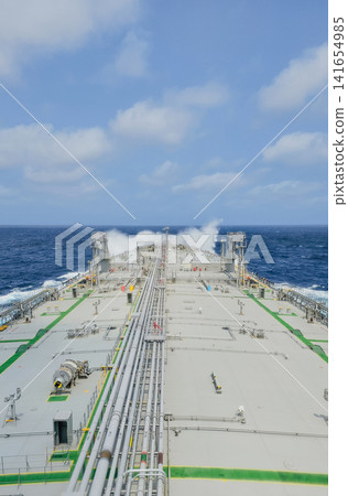 Vertical view of large industrial oil tanker vessel deck with pipeline system sailing in rough open blue ocean for global maritime cargo logistics stock photo Vertical view of large industrial oil tanker vessel deck with pipeline system sailing in rough open blue ocean for global maritime cargo logistics stock photo 141654985