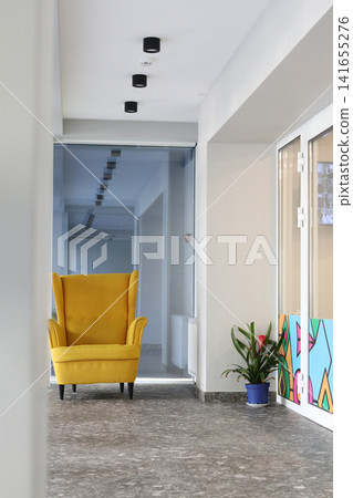 Part of the lobby interior with a yellow armchair. Part of the lobby interior with a yellow armchair. 141655276