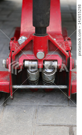 A red car hydraulic lift. A red car hydraulic lift. 141655298