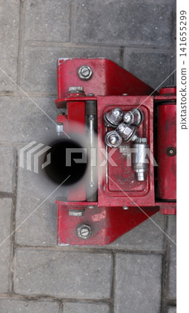A red car hydraulic lift. A red car hydraulic lift. 141655299