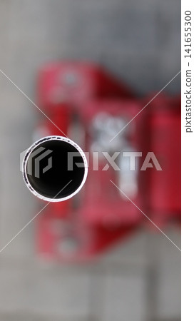 A red car hydraulic lift. A red car hydraulic lift. 141655300