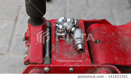 A red car hydraulic lift. A red car hydraulic lift. 141655301