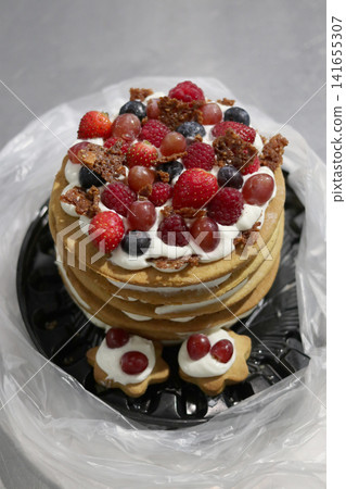 Delicious crepe cake with fresh berries. 141655307