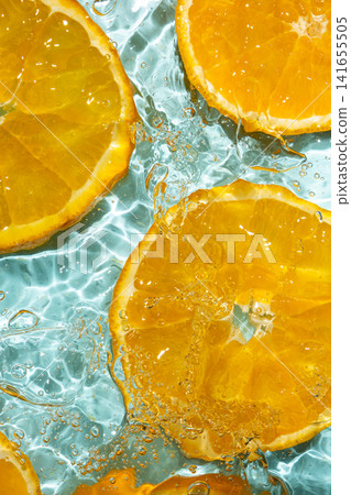 Top view of fresh orange slices submerged in clear rippling water Top view of fresh orange slices submerged in clear rippling water 141655505