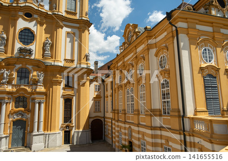 Stift Melk benedictine monastery architecture with beautiful yellow facades and decorative windows Stift Melk benedictine monastery architecture with beautiful yellow facades and decorative windows 141655516