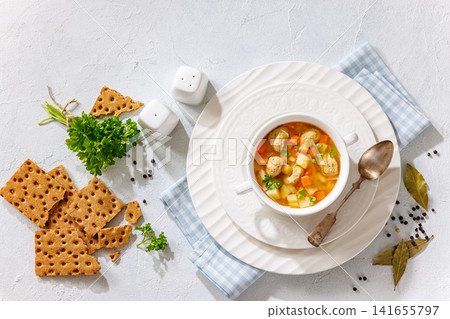 turkey meatball soup with carrots and potato 141655797