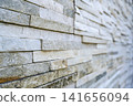 Improved texture of exterior walls clad in white stone-pattern siding in Tokyo 141656094