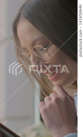 Vertical video. Close up woman using app on smartphone in cafe. Vertical video. Close up woman using app on smartphone in cafe. 141656646