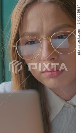 Vertical video. Closeup portrait of smiling businesswoman working at modern office and using computer touchscreen, looking at monitor. 141656654