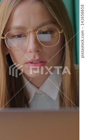Vertical video. Closeup portrait of businesswoman working at modern office and using computer touchscreen, looking at monitor. Vertical video. Closeup portrait of businesswoman working at modern office and using computer touchscreen, looking at monitor. 141656658