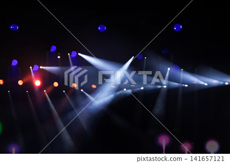 Colorful stage lights illuminate an electrifying concert atmosphere at night Colorful stage lights illuminate an electrifying concert atmosphere at night 141657121