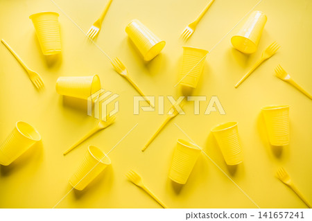 Disposable picnic utensils for recycling on yellow. Environment eco friendly discarded plastic garbage for recycle concept.Top view. Flat lay. Disposable picnic utensils for recycling on yellow. Environment eco friendly discarded plastic garbage for recycle concept.Top view. Flat lay. 141657241