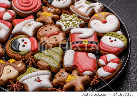 Gingerbread as a Christmas staple, sweet biscuits for the holiday. Gingerbread as a background Gingerbread as a Christmas staple, sweet biscuits for the holiday. Gingerbread as a background 141657333