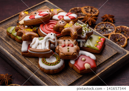 Gingerbread as a Christmas staple, sweet biscuits for the holiday. Gingerbread as a background Gingerbread as a Christmas staple, sweet biscuits for the holiday. Gingerbread as a background 141657344
