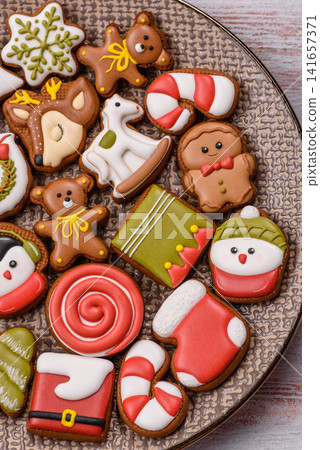 Gingerbread as a Christmas staple, sweet biscuits for the holiday. Gingerbread as a background Gingerbread as a Christmas staple, sweet biscuits for the holiday. Gingerbread as a background 141657371