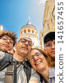 Istanbul, turkey, august 2, 2025. Happy family of four taking a selfie while exploring the historic galata tower and city architecture in istanbul, turkey 141657455