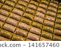 Istanbul, turkey, august 2, 2025. Rows of traditional turkish baklava rolls featuring a blend of pistachio and rich syrup, forming a delicious middle eastern dessert 141657460