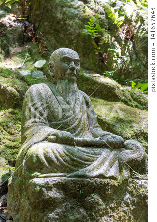 Monk statue in serene Mitaki-Dera temple garden in Hiroshima Monk statue in serene Mitaki-Dera temple garden in Hiroshima 141657643