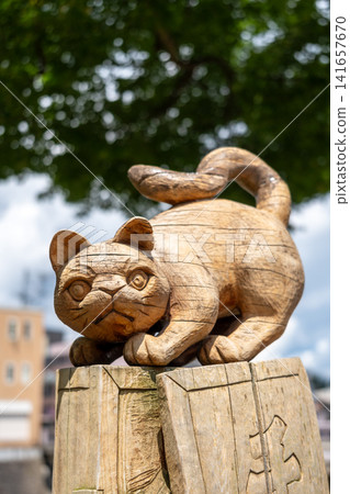 Wooden cat statue by Miyagawa River in Takayama, Japan Wooden cat statue by Miyagawa River in Takayama, Japan 141657670