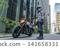 A male rider and his Vulcan S stand in the skyscraper district of Tokyo. 141658331