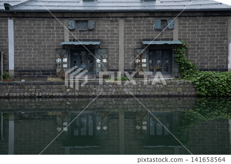 Historic warehouses and beautiful reflections in the water along the Otaru Canal. Historic warehouses and beautiful reflections in the water along the Otaru Canal. 141658564