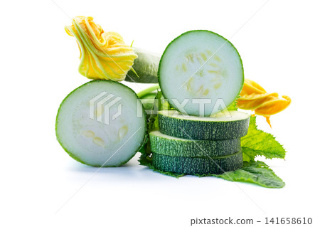Raw organic zucchini with yellow blossoms and white studio background Raw organic zucchini with yellow blossoms and white studio background 141658610