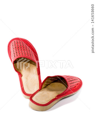 Red women's slippers on a white background Red women's slippers on a white background 141658660