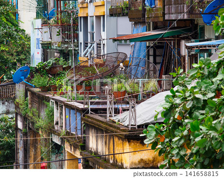 Weathered apartment buildings and hanging laundry in downtown Yangon, Myanmar, showing everyday urban life and dense local architecture Weathered apartment buildings and hanging laundry in downtown Yangon, Myanmar, showing everyday urban life and dense local architecture 141658815