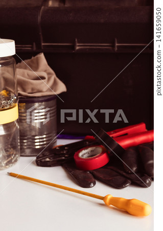 Handyman tools and equipment with a toolbox on a white background, preparing for repair work, maintenance, construction, and home improvement projects Handyman tools and equipment with a toolbox on a white background, preparing for repair work, maintenance, construction, and home improvement projects 141659050