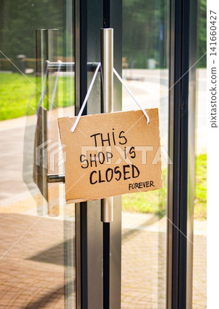 SHOP IS CLOSED FOREVER sign hanging on small shop door. Small business shutting down due to financial crisis. Local business unable to survive economic pressure SHOP IS CLOSED FOREVER sign hanging on small shop door. Small business shutting down due to financial crisis. Local business unable to survive economic pressure 141660427