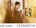 A profile view of a woman in mourning attire with her eyes closed and hands clasped in prayer. A profile view of a woman in mourning attire with her eyes closed and hands clasped in prayer. 141660514