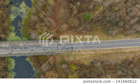 Aerial road and bridge over marshy river in rural Belarus Aerial road and bridge over marshy river in rural Belarus 141660622