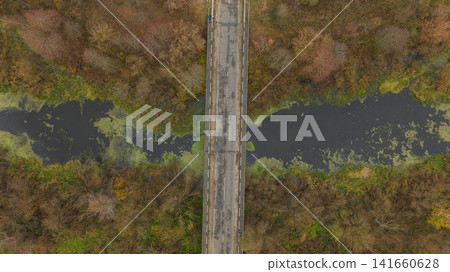 Aerial bridge over winding river with marsh and leafless trees, Belarus Aerial bridge over winding river with marsh and leafless trees, Belarus 141660628