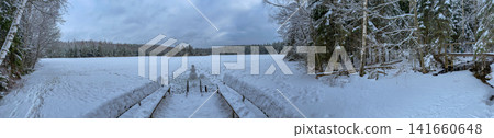 Panoramic winter lake with boardwalk, snowman, and frosted forest Panoramic winter lake with boardwalk, snowman, and frosted forest 141660648
