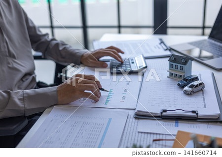 Financial advisor analyzing real estate and car loan budget percentages. Real estate and automotive financial planning concept. Financial advisor analyzing real estate and car loan budget percentages. Real estate and automotive financial planning concept. 141660714