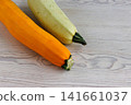 Yellow and pale green zucchini on white wooden table with copy space. Selective focus Yellow and pale green zucchini on white wooden table with copy space. Selective focus 141661037