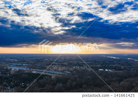 Aerial suburban outskirts near Warsaw at sunset with storm clouds Aerial suburban outskirts near Warsaw at sunset with storm clouds 141661425